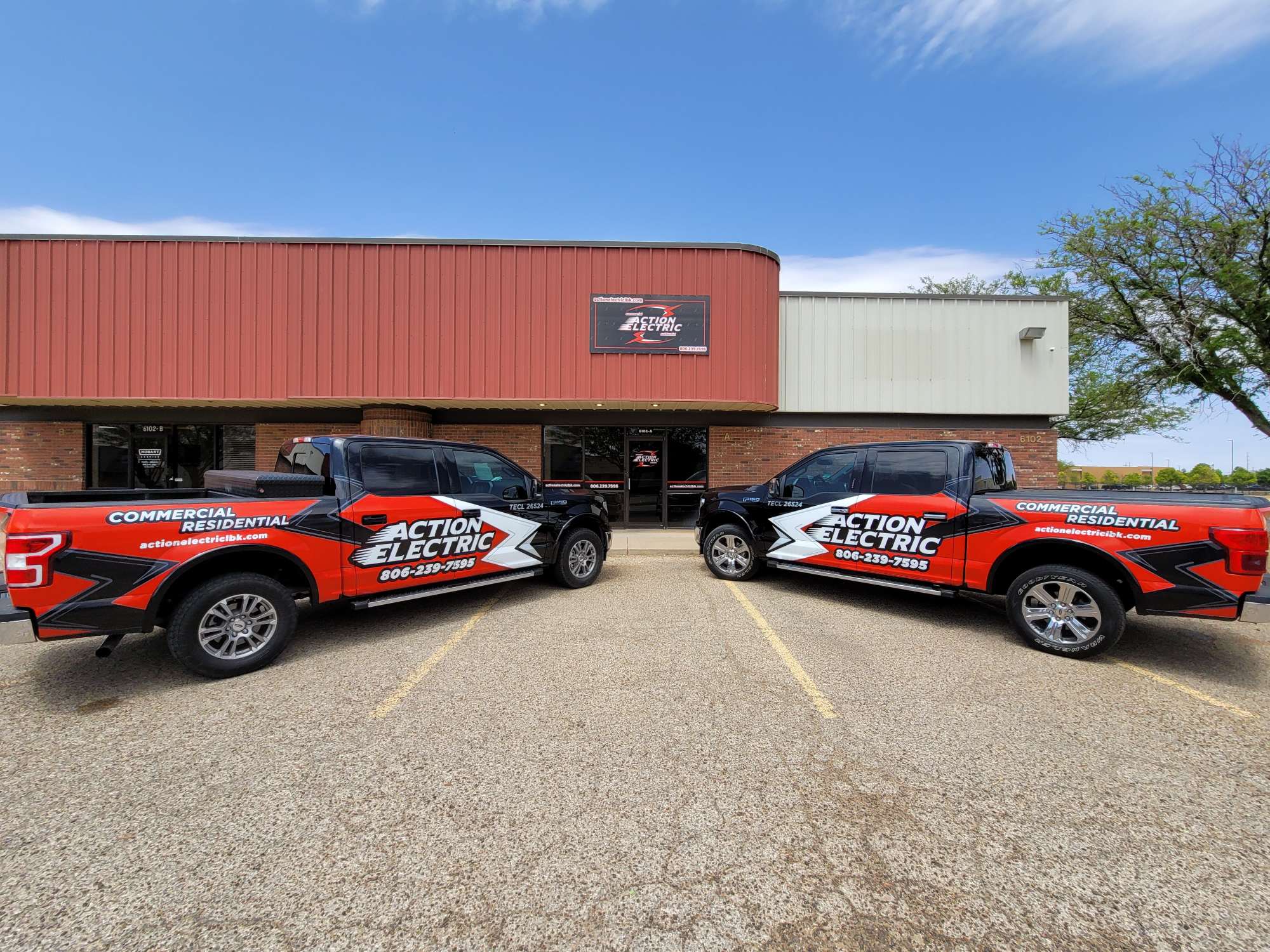 Action Electric headquarters with branded trucks